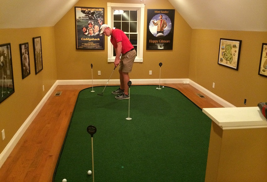 man playing on indoor putting green